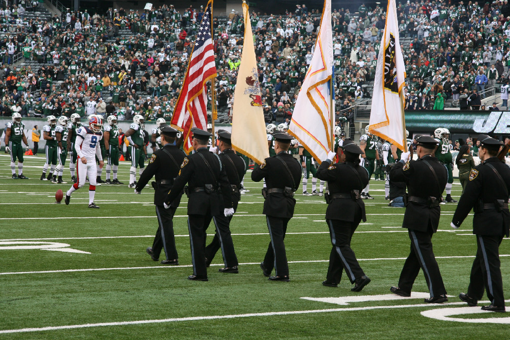 Honor Guard marches on to the field. 
